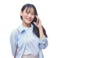 Portrait professional business young Asian woman is walking to office or work place while she holds talks to customer on the phone with smartphone isolated on white background. photo