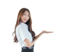 Portrait of young Thai student in university student uniform. Asian pretty girl standing to present something confidently while isolated on white background. photo