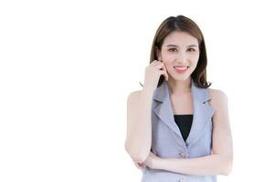 Asian professional working woman has black long hair in gray shirt. She is smiling and standing confident while isolated on white background. photo