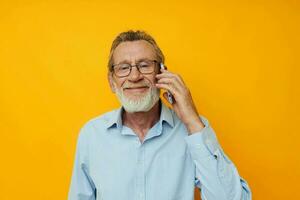 old man talking on the phone emotions yellow background photo