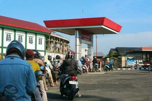 Wonosobo, Indonesia - April 5, 2023 - Queue of vehicles refueling at Pertamina Gas Station photo