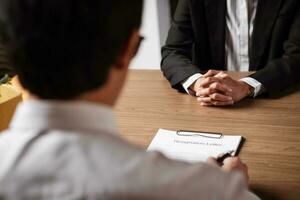 Image of employer or recruiter holding reading a resume during about colloquy his profile of candidate. photo