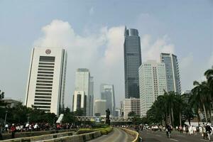 Jakarta, Indonesia-18 June 2023 view of sudirman street with sudirman statue in the middle photo