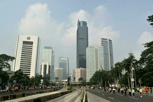 Jakarta, Indonesia-18 June 2023 view of sudirman street with sudirman statue in the middle photo