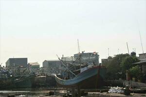 Jakarta, Indonesia-18 June 2023 fishing boats parked on the coast of Jakarta photo