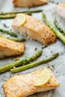 Baked Delicious salmon, green asparagus and lemon in pan photo