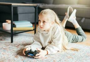 Girl playing video game at home photo