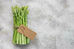 Fresh green asparagus on  concrete background. photo