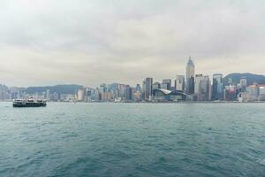 Hong Kong,March 25,2019-View of the Hong Kong skyscrapers from the ferrie crossing the Victoria Harbour during a cloudy day photo