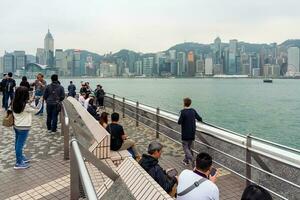Hong Kong,March 25,2019-View of the Hong Kong skyscrapers from the Avenue of star on  the Victoria Harbour during a cloudy day photo