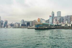 Hong Kong,March 25,2019-View of the Hong Kong skyscrapers from the ferrie crossing the Victoria Harbour during a cloudy day photo