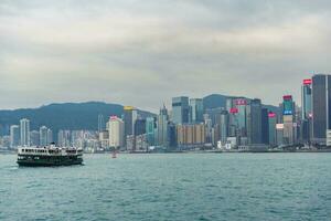 Hong Kong,March 25,2019-View of the Hong Kong skyscrapers from the ferrie crossing the Victoria Harbour during a cloudy day photo
