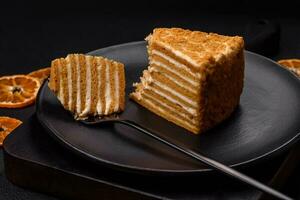 Delicious fresh sweet honey cake layer cake with white cream photo