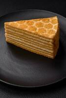 Delicious fresh sweet honey cake layer cake with white cream photo