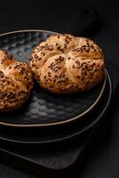 Delicious freshly baked crispy bun or kaiser roll with sesame seeds photo