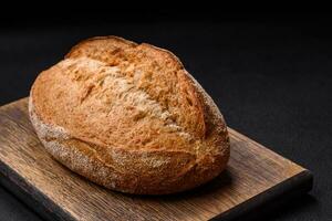 Delicious fresh baked crispy loaf of bread with seeds and grains photo