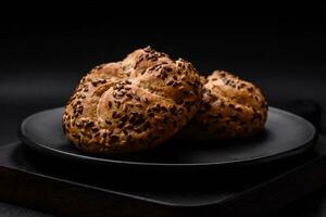 Delicious freshly baked crispy bun or kaiser roll with sesame seeds photo