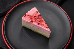 Delicious sweet dessert cheesecake with raspberry and pistachio flavor photo