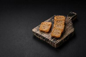 Delicious salted rectangular wheat croutons with salt and spices photo