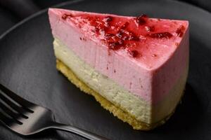 Delicious sweet dessert cheesecake with raspberry and pistachio flavor photo