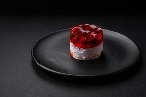 Delicious fresh sweet cheesecake cake with berries and red color jelly photo