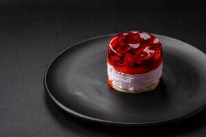 Delicious fresh sweet cheesecake cake with berries and red color jelly photo