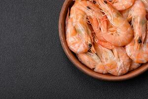 Delicious fresh boiled tiger prawns with salt and spices on a ceramic plate photo