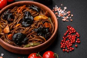 Delicious fresh buckwheat noodles or udon with mushrooms, peppers and other vegetables photo