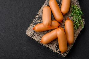 Delicious fresh boiled sausages with salt, spices and herbs photo