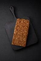 Delicious fresh crispy brown bread with seeds and grains cut into slices photo