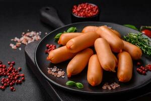 Delicious fresh boiled sausages with salt, spices and herbs photo