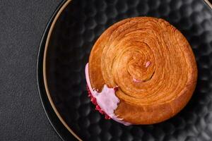 Round puff pastry croissant with raspberry filling or new york roll photo