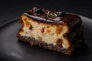 Delicious sweet dessert cheesecake with candied fruits in chocolate photo