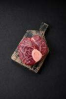 Fresh raw beef steak with bone or ossobuco with salt, spices and herbs photo