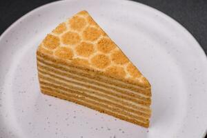 Delicious fresh sweet honey cake layer cake with white cream photo