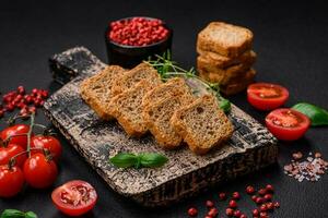 Delicious salted rectangular wheat croutons with salt and spices photo