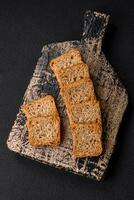 Delicious salted rectangular wheat croutons with salt and spices photo