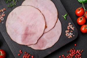 Delicious fresh ham cut into round slices with salt, spices and herbs photo