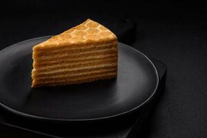 Delicious fresh sweet honey cake layer cake with white cream photo