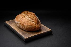 Delicious fresh baked crispy loaf of bread with seeds and grains photo