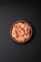 Delicious fresh boiled tiger prawns with salt and spices on a ceramic plate photo