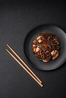 Delicious fresh buckwheat noodles with boiled tiger prawns, salt, spices and mushrooms photo