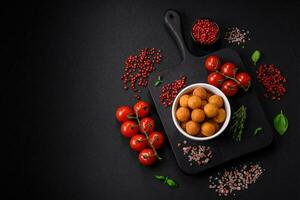 Delicious fried potato balls with breaded mozzarella, salt, spices and herbs photo