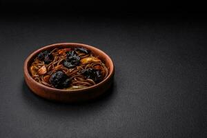 Delicious fresh buckwheat noodles or udon with mushrooms, peppers and other vegetables photo