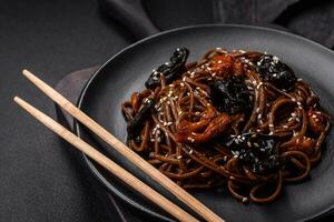 Delicious fresh buckwheat noodles or udon with mushrooms, peppers and other vegetables photo