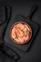 Delicious fresh boiled tiger prawns with salt and spices on a ceramic plate photo