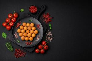 Delicious fried potato balls with breaded mozzarella, salt, spices and herbs photo