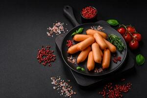 Delicious fresh boiled sausages with salt, spices and herbs photo