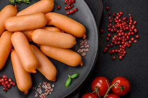 Delicious fresh boiled sausages with salt, spices and herbs photo