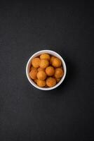 Delicious fried potato balls with breaded mozzarella, salt, spices and herbs photo